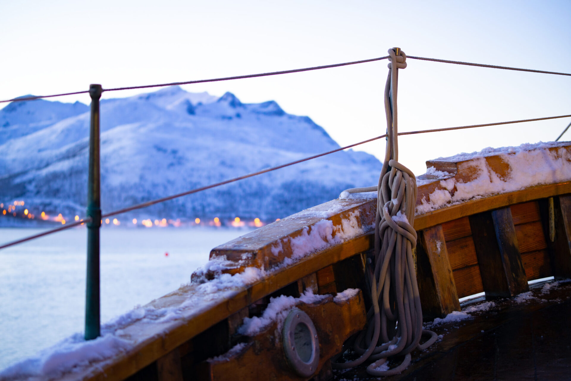 View over the front of a wooden sailing schooner. Norwegian fjor